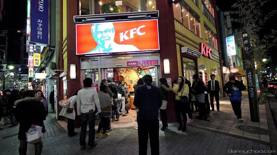 Des personnes font la queue devant un restaurant KFC dans une rue de Tokyo pendant la p&eacute;riode de No&euml;l en 2010.